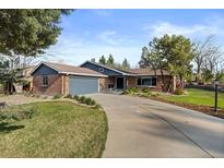 Charming single-story brick home with an attached garage and well-manicured front yard at 10801 W 29Th Ave, Lakewood, CO 80215
