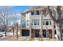 Charming townhome with brick accents, large windows, and a convenient covered parking area at 2503 N Ogden St, Denver, CO 80205