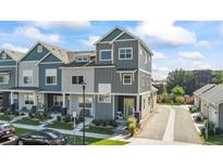 Attractive modern townhome with gray siding, professional landscaping, and a welcoming front porch at 1530 Terry St, Longmont, CO 80501