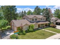 Charming two-story home boasts lush landscaping and a welcoming front porch at 4810 W 102Nd Pl, Westminster, CO 80031
