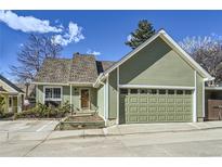 Charming home with green siding, attached garage, and well-maintained landscaping at 4861 Curie Ct, Boulder, CO 80301