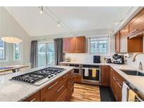 Spacious kitchen features wood cabinets, granite countertops, stainless steel appliances, and a gas cooktop at 4861 Curie Ct, Boulder, CO 80301