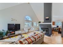 Bright living room with vaulted ceilings, fireplace, and stylish decor at 4861 Curie Ct, Boulder, CO 80301