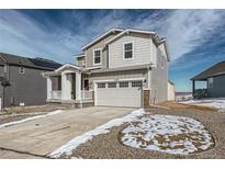 Charming two-story home featuring a two-car garage, covered porch, and well-maintained landscaping at 13832 Honey Hush Trl, Parker, CO 80134