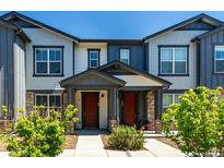 Charming townhome with a covered entry and well-maintained landscaping at 157 Ambrose St, Erie, CO 80516