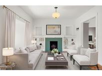 Bright living room featuring a fireplace, built-in bookshelves, and elegant decor at 841 Niagara St, Denver, CO 80220