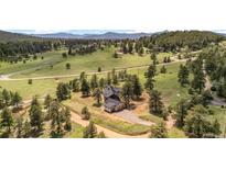 Stunning aerial view of the home and surroundings, with a paved driveway and a three car garage at 25350 Ridge Way, Golden, CO 80401