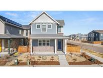 Charming two-story home with blue siding, brick accents, and a well-manicured front yard at 21393 E 59Th Pl, Aurora, CO 80019