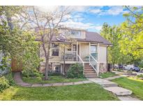 Charming home featuring stone accents, a well-manicured lawn, and a inviting front porch with elegant railings at 2507 9Th St, Boulder, CO 80304