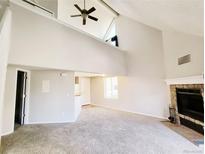 Bright living room with vaulted ceiling, fireplace, and open layout perfect for entertaining at 5250 S Huron Way # 312, Littleton, CO 80120