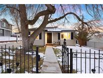 Charming single-story home with a fenced yard, mature tree, and welcoming entryway at 5231 Quitman St, Denver, CO 80212