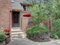 Charming home with brick facade, landscaped yard and inviting front entrance at 11867 Elk Head Range Rd, Littleton, CO 80127