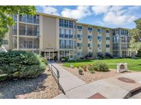 Attractive condo building with a manicured lawn and professional landscaping at 13626 E Bates Ave # 207, Aurora, CO 80014