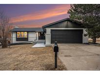 Updated Ranch home exterior boasts a fresh coat of paint and modern finishes at 6714 Depew St, Arvada, CO 80003