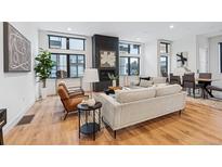 Bright living room features hardwood floors, fireplace, and ample natural light at 838 Ash St # 1, Denver, CO 80220