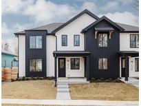 Modern two-story home with black and white accents, large windows, and a well-manicured front yard at 4135 Benton Street, Denver, CO 80212