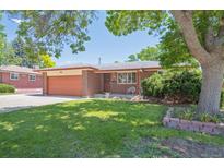 Charming single-story brick home with a well-maintained lawn and mature landscaping at 1774 S Dover Way, Lakewood, CO 80232