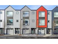 Modern townhomes boast gray siding, large windows, and individual garages for convenient urban living at 5531 W 11Th Pl, Lakewood, CO 80214