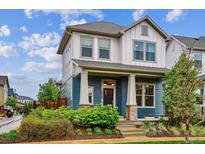 Charming two-story home with a beautifully landscaped front yard and inviting porch at 10360 E 57Th Pl, Denver, CO 80238
