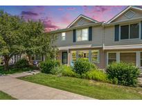Charming townhome with well-maintained lawn and mature trees, perfect for comfortable living at 64 N Harlan St, Lakewood, CO 80226