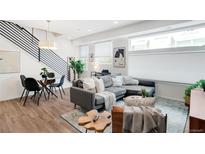 Bright living space with modern furniture, light wood floors, and staircase with iron railings at 1238 Quitman St # 2, Denver, CO 80204