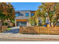 Modern two-story home with wood fence and attached garage at 3485 S Clermont St, Denver, CO 80222