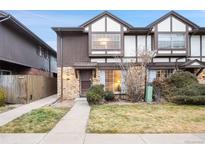 Exterior view of a two-story townhome with a small front yard and walkway at 3855 S Monaco St # 176, Denver, CO 80237
