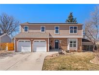 Charming two-story home featuring a two-car garage, brick accents, solar panels and manicured landscaping at 4725 S Xenon Way, Morrison, CO 80465