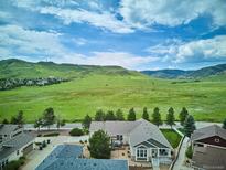 Stunning aerial view of a home backing to open space with mountain views at 5603 Van Bibber Ct, Golden, CO 80403