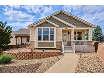 Charming single-Gathering home with manicured landscaping, stone accents, and welcoming front porch at 5603 Van Bibber Ct, Golden, CO 80403
