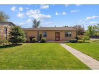 Charming single-story home featuring a well-maintained lawn and inviting walkway to front door at 998 S Leyden St, Denver, CO 80224