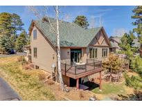 Charming two-story home with a green roof, and a cozy outdoor deck and an inviting ambiance at 1294 Red Lodge Dr, Evergreen, CO 80439