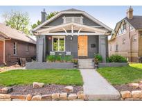 Charming home with a craftsman-style front exterior and a well-manicured lawn and stone landscaping at 277 S Gilpin St, Denver, CO 80209