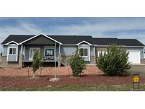 Charming single-story home featuring a mix of siding and brick, manicured landscaping, and an attached two car garage at 14545 Barksdaly Way, Keenesburg, CO 80643