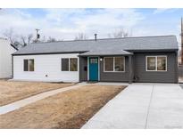 Charming single-story home with a blue door, light grey roof, and a newly updated front yard at 3045 S Grape Way, Denver, CO 80222