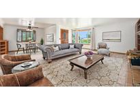 Spacious living room with large windows, hardwood floors, and comfortable seating at 3790 W 54Th Ave, Denver, CO 80221