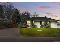 Charming single-story home with a well-maintained lawn and mature landscaping at 1335 S Holly St, Denver, CO 80222