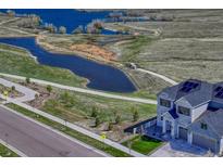Beautiful two story home with modern architecture and manicured front yard, near a tranquil community pond at 6860 S Yantley Ct, Aurora, CO 80016