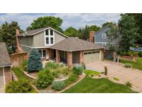 Inviting front yard featuring a well-maintained lawn and thoughtfully designed landscaping at 8167 S Wabash Ct, Centennial, CO 80112
