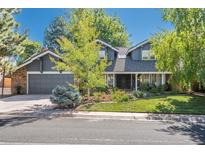 Charming two-story home with a beautifully landscaped front yard and a gray two car garage at 7844 S Eudora Cir, Centennial, CO 80122