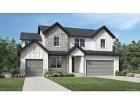 Two-story house with gray siding, stone accents, and a two-car garage at 5816 Las Rosas Dr, Parker, CO 80134