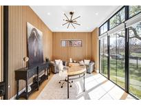 Bright home office with wood paneled walls, stylish decor, modern lighting and large windows offering plenty of sunlight at 754 S York St, Denver, CO 80209