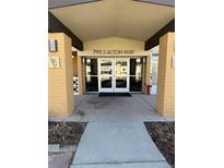 The building entrance is covered and clearly marked with the address above the glass doors at 795 S Alton Way # 11C, Denver, CO 80247