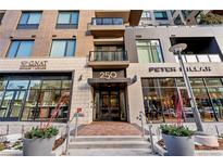 Modern building exterior with glass and stone accents, showcasing a main entrance at 250 Columbine St # 210, Denver, CO 80206