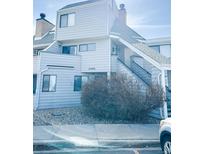 Charming two-story condo featuring a light blue exterior and well-maintained landscaping at 17090 E Ford Dr # 209, Aurora, CO 80017