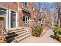 Charming brick townhouse featuring a welcoming front door, steps, and inviting curb appeal at 2660 S University Blvd # B, Denver, CO 80210