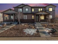 Charming townhome with a covered porch and landscaped front yard, perfect for relaxing evenings at 7267 S Millbrook Ct, Aurora, CO 80016