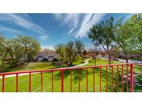 A scenic view of the property's lush green lawn, mature trees and walkways on a partly cloudy day at 12120 Melody Dr # 308, Westminster, CO 80234