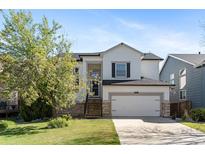 Charming two-story home featuring a well-manicured lawn and a two-car garage at 8864 S Field Ct, Littleton, CO 80128