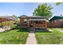 Charming brick home featuring a covered front porch and well-maintained lawn at 2564 S Acoma St, Denver, CO 80223
